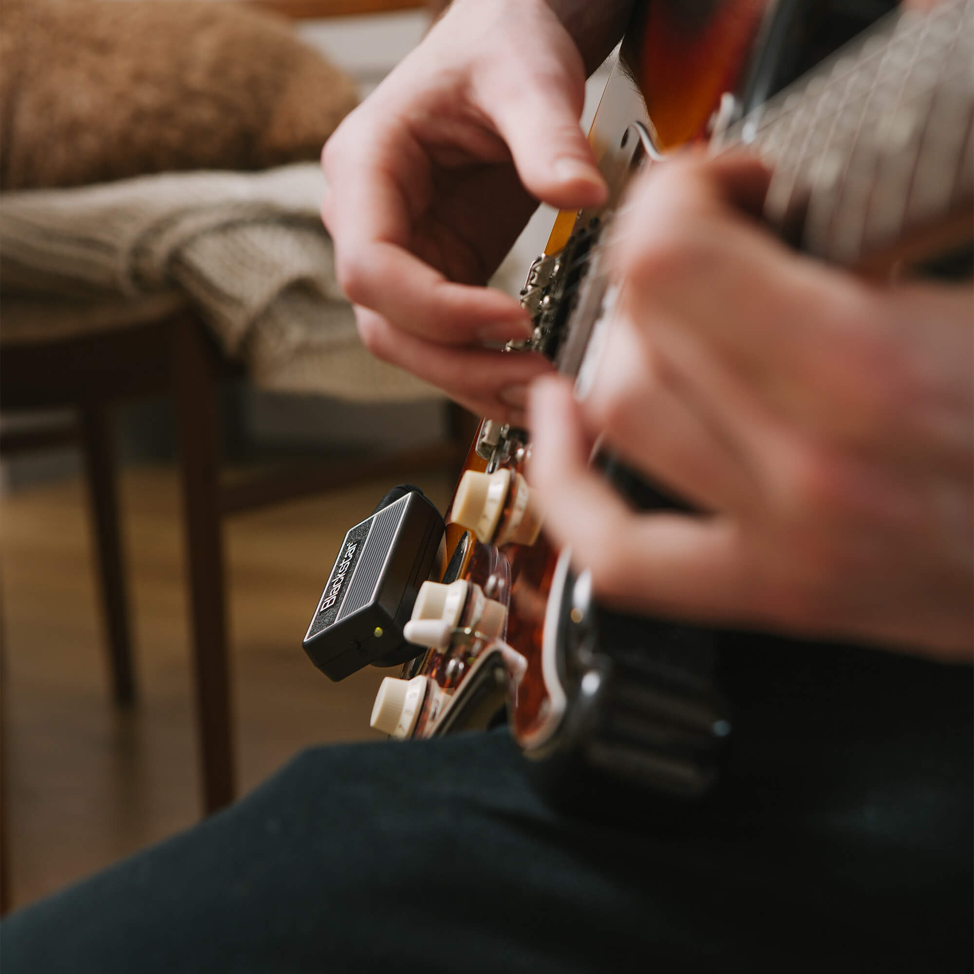 guitar player strumming guitar with Blackstar amPlug 2 FLY guitar amp plugged into guitar and headphones
