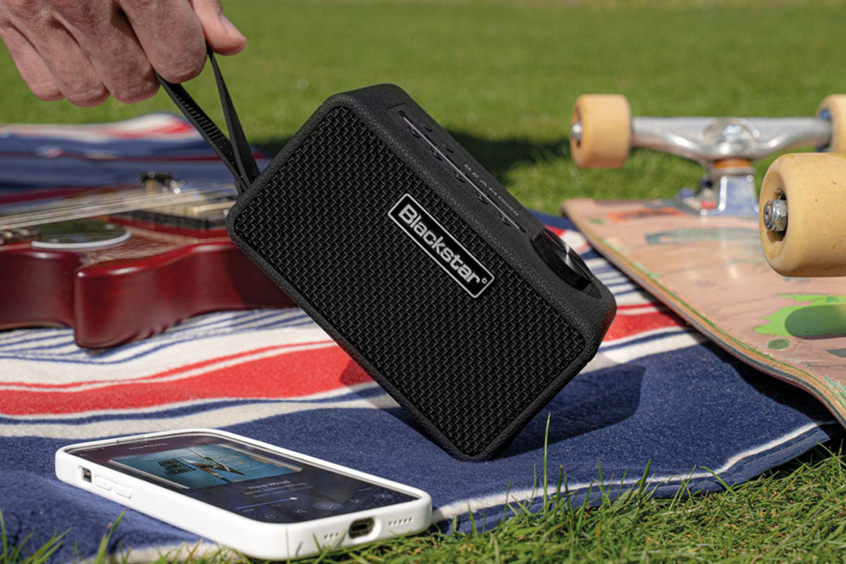 BEAM Mini on blanket with a phone and skateboard side