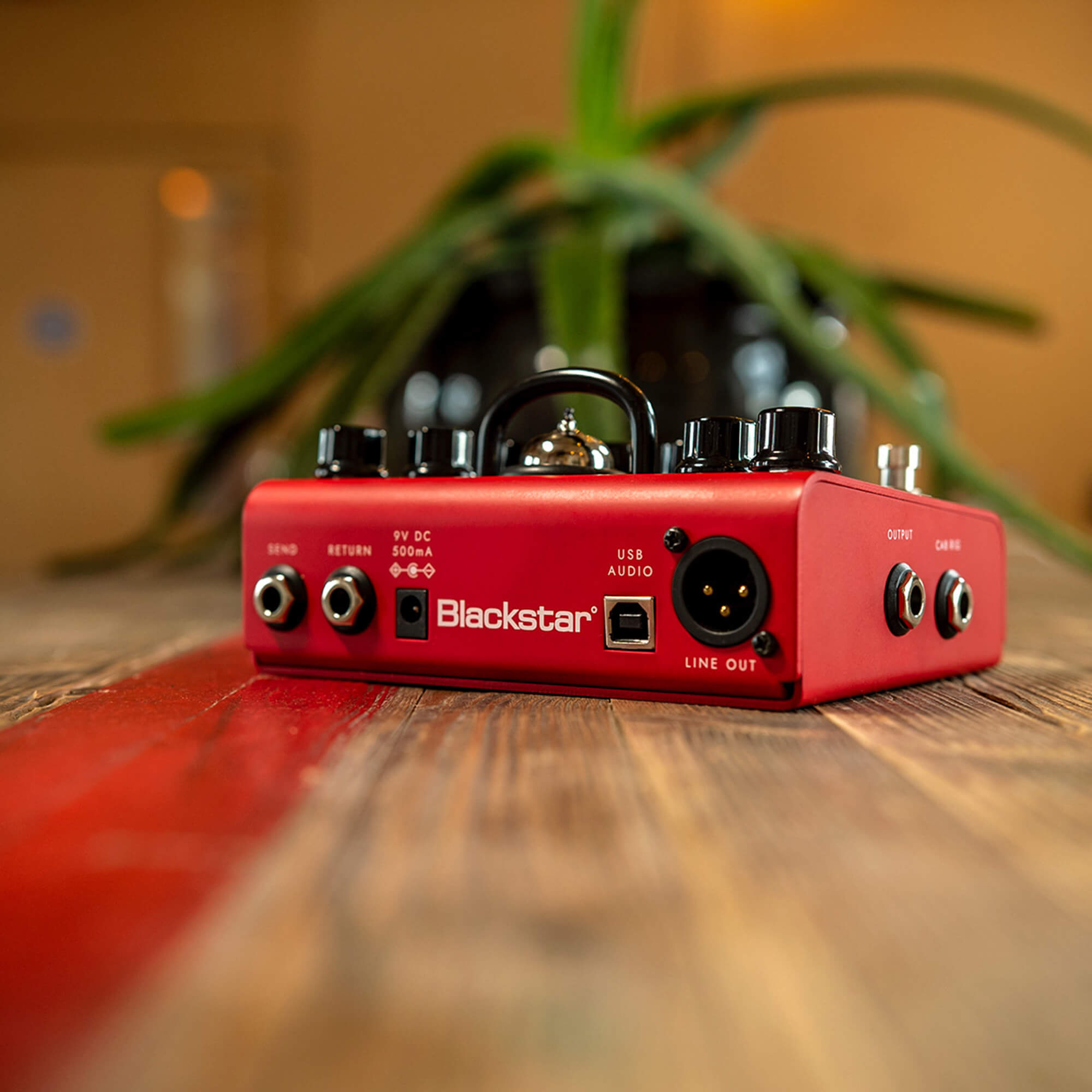 Blackstar Dept 10 Dual Drive guitar pedal in bold red on wood floor
