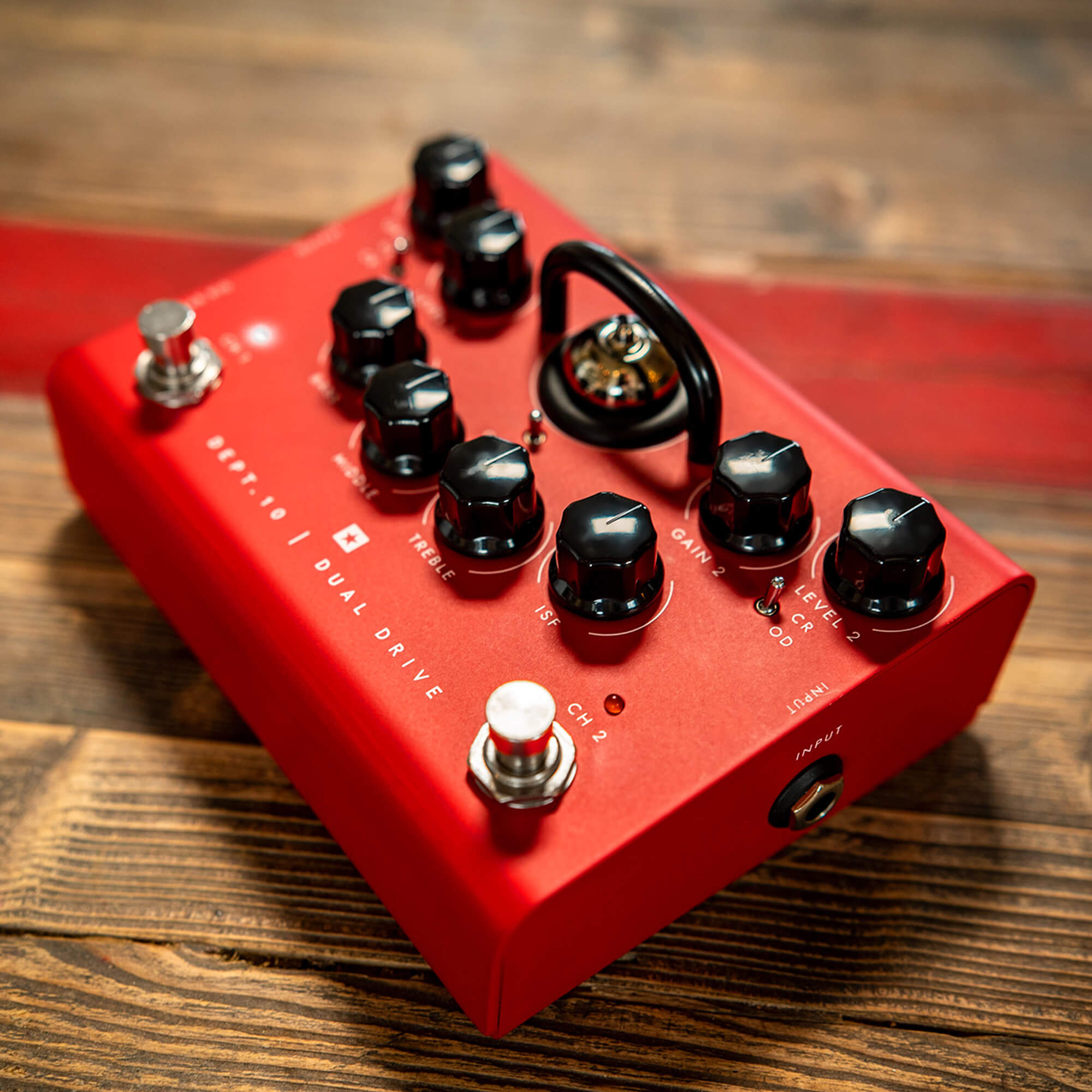 Blackstar Dept 10 Dual Drive guitar pedal in bold red on wood floor