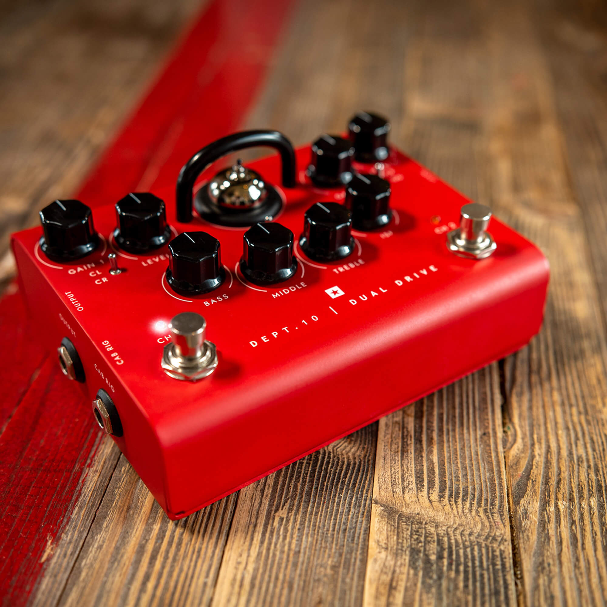 Blackstar Dept 10 Dual Drive guitar pedal in bold red on wood floor