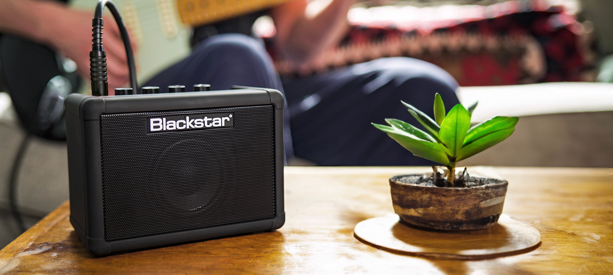 guitar player plugged into Blackstar Amps FLY 3 Charge mini guitar amplifier