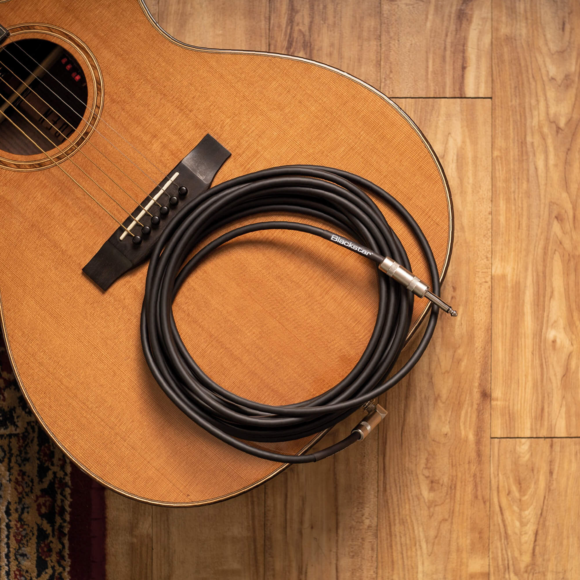 Blackstar instrument cable on an acoustic guitar